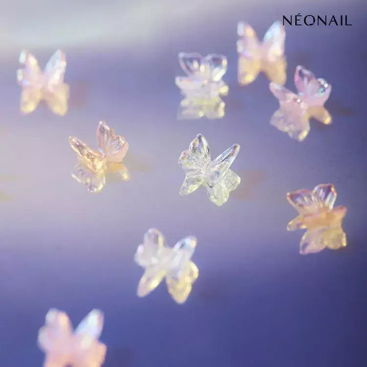 3D butterflies nail art ornaments in shimmery colors, enhancing gel nails with a charming touch for DIY manicures.