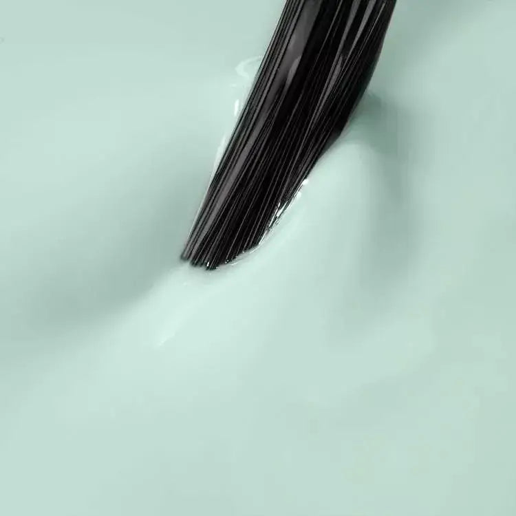 Mint UV gel polish being applied, perfect for DIY manicures and spring nail trends. Ideal for nail care and home nail kits.