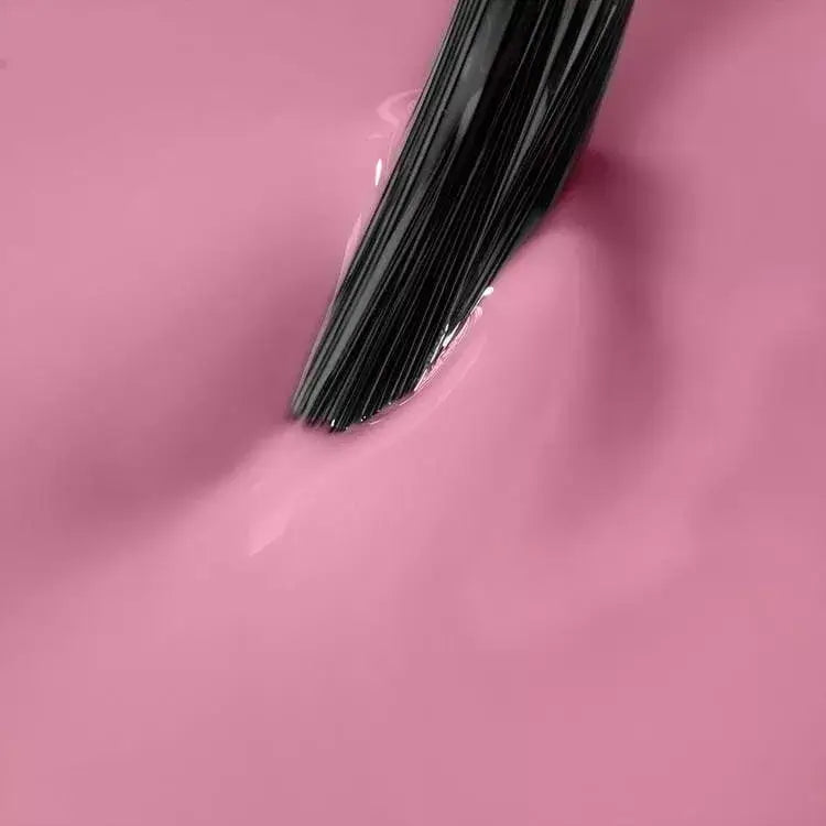 Close-up of Stellar Pink UV gel polish with brush, showcasing its creamy texture for perfect gel nails.