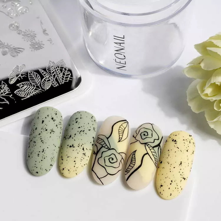 Nail art using Stamping Plate 09 with floral designs on gel polish nails in shades of green and yellow.