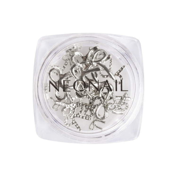 3D silver decoration bows in a clear container, perfect for enhancing gel nail art and home manicure kits.