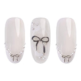 Three elegant nails featuring silver 3D bows and pearls, perfect for a stylish manicure with gel polish.
