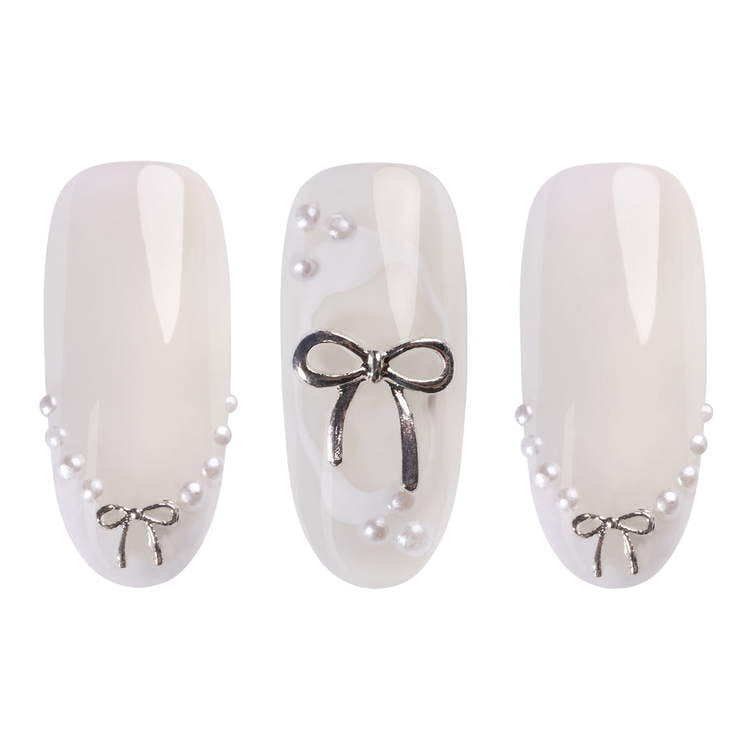 Three elegant nails featuring silver 3D bows and pearls, perfect for a stylish manicure with gel polish.