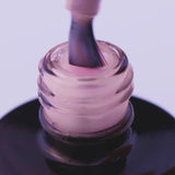Close-up of expert-level pale pink UV gel in a bottle with brush, ideal for bright nail art and easy application.