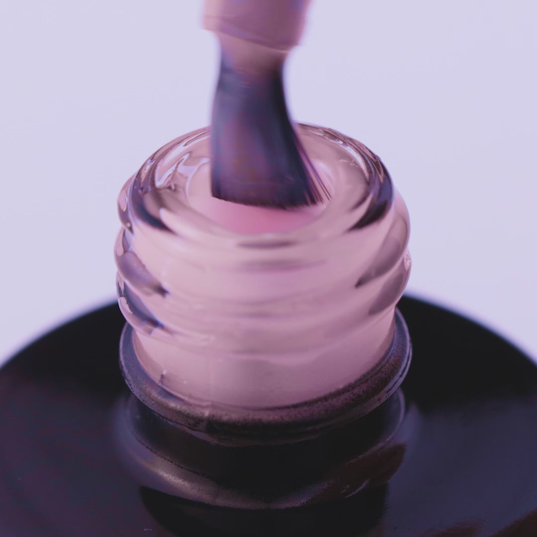 Close-up of expert-level pale pink UV gel in a bottle with brush, ideal for bright nail art and easy application.