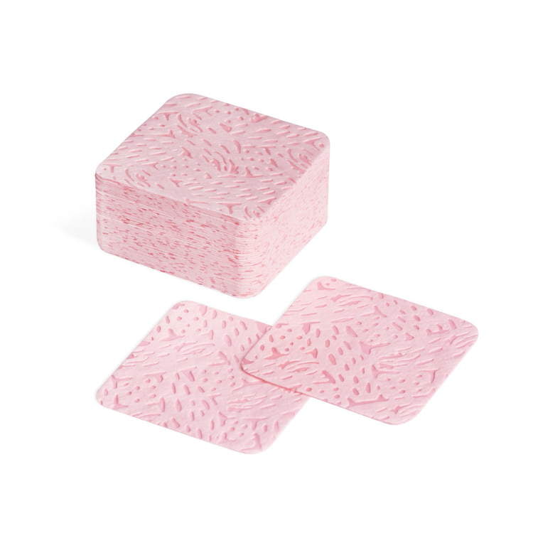 Perforated pink cotton pads, lint-free, suitable for UV gel nail polish and home nail care kits.